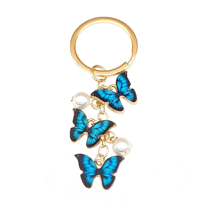 Keychains de metal de perlas de imitación de mariposa de aceite de aceite de color al tanto